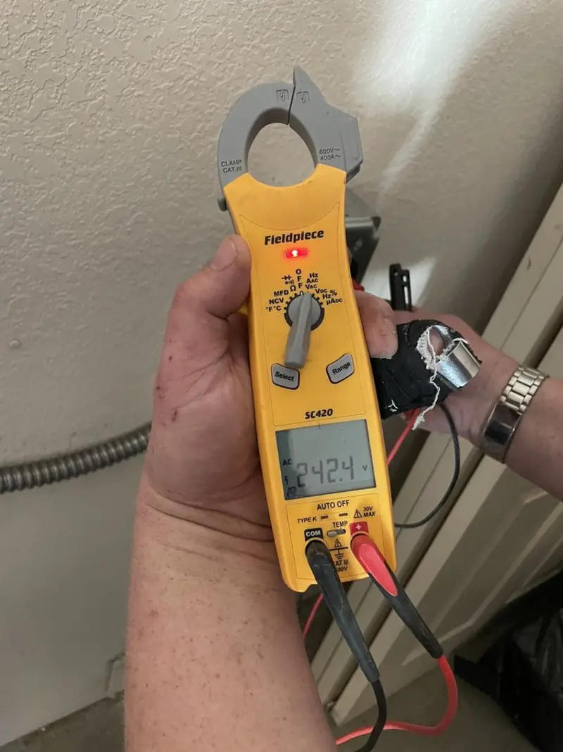 Voltage testing with clamp meter during Outlet Installation in Poquoson